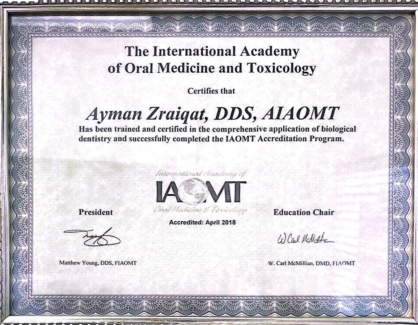 Certificate from the International Academy of Oral Medicine and Toxicology, awarded to Ayman Zraiqat, DDS, AIAOMT, for completing the IAOMT Accreditation Program.